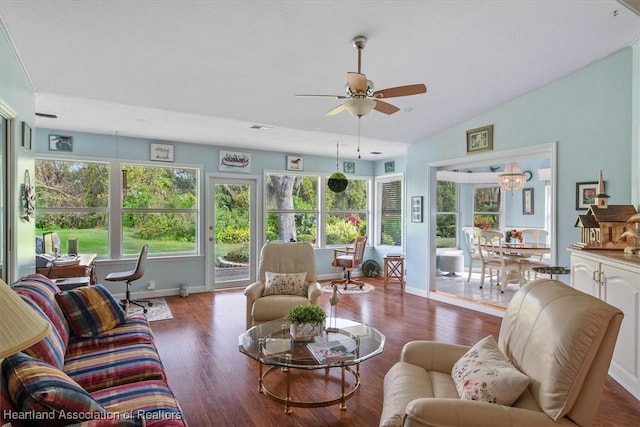 sunroom featuring ceiling fan with notable chandelier