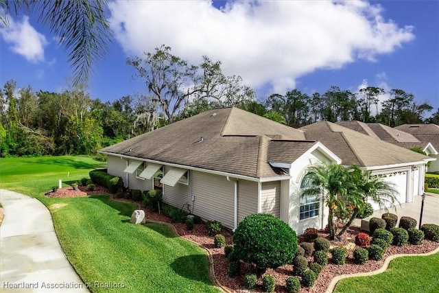 view of front of house featuring a front yard and a garage