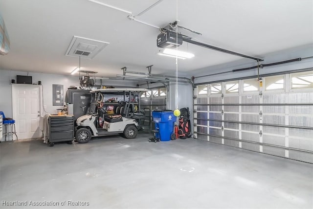 garage featuring electric panel and a garage door opener