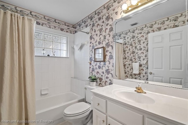 full bathroom featuring vanity, toilet, and shower / bathtub combination with curtain