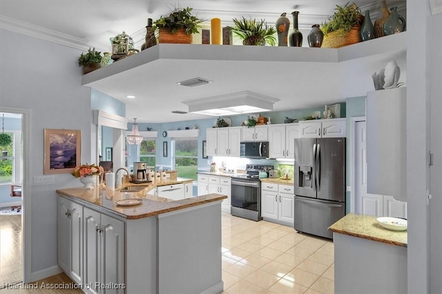 kitchen with white cabinets, kitchen peninsula, sink, and appliances with stainless steel finishes