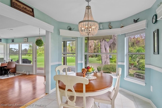 sunroom / solarium with a chandelier