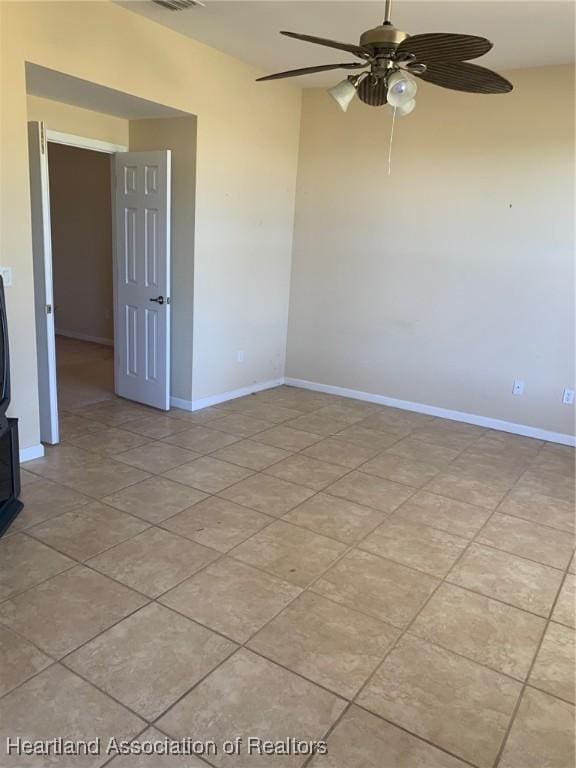 unfurnished room with visible vents, baseboards, a ceiling fan, and light tile patterned flooring