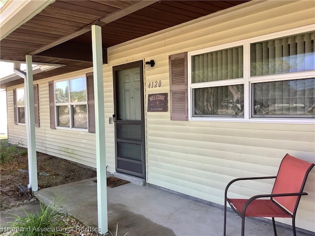 view of exterior entry with covered porch