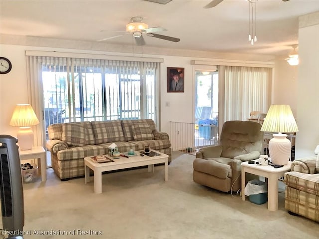 carpeted living room featuring ceiling fan