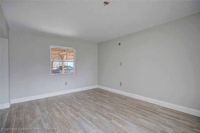 spare room with light hardwood / wood-style floors