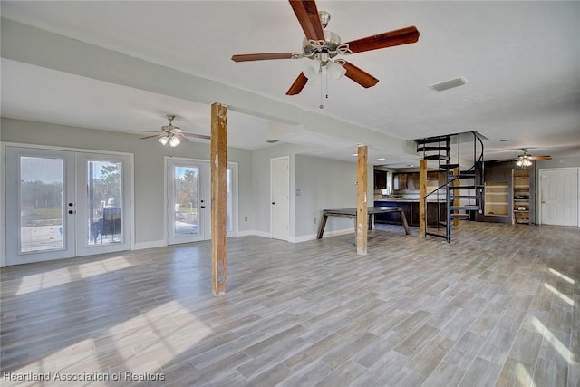 living room featuring ceiling fan, french doors, and light hardwood / wood-style flooring