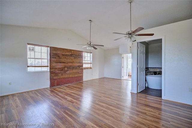 unfurnished living room featuring dark hardwood / wood-style flooring and lofted ceiling