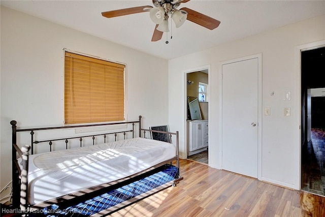 bedroom with ceiling fan, ensuite bath, and wood-type flooring