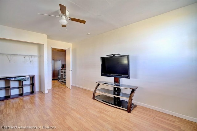 living room with ceiling fan and hardwood / wood-style floors