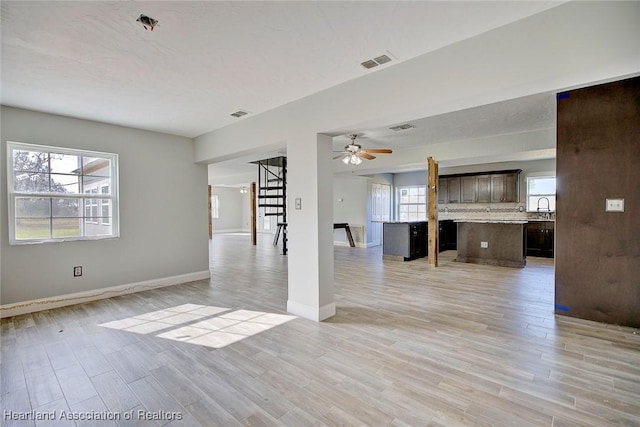 spare room featuring a wealth of natural light and light wood-type flooring