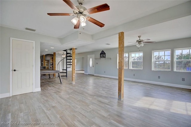 unfurnished living room with ceiling fan and light hardwood / wood-style flooring