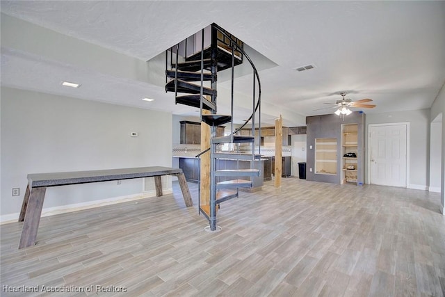 interior space with ceiling fan and light hardwood / wood-style floors