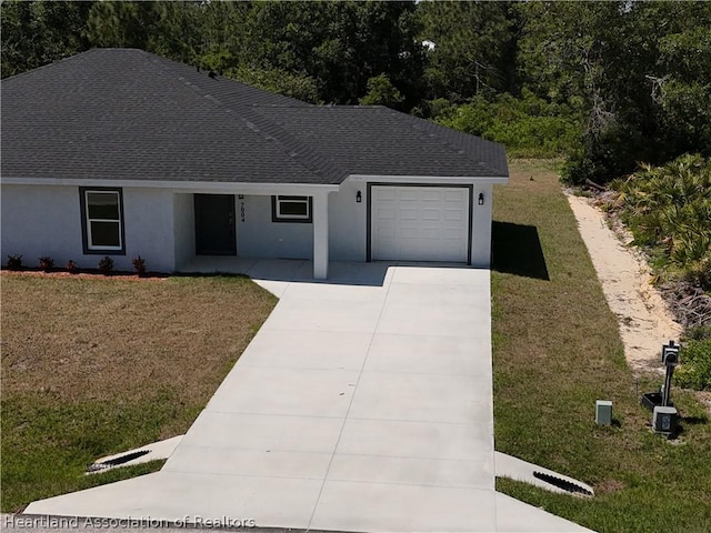 view of front facade with a front yard and a garage