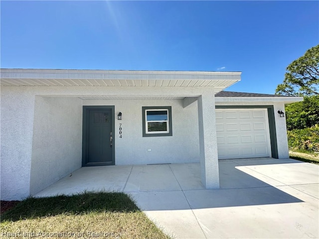 view of exterior entry featuring a garage