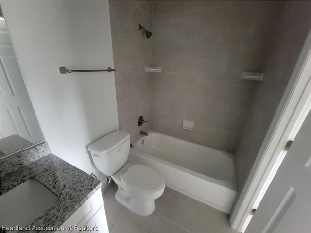 full bathroom featuring tile patterned flooring, vanity, tiled shower / bath combo, and toilet