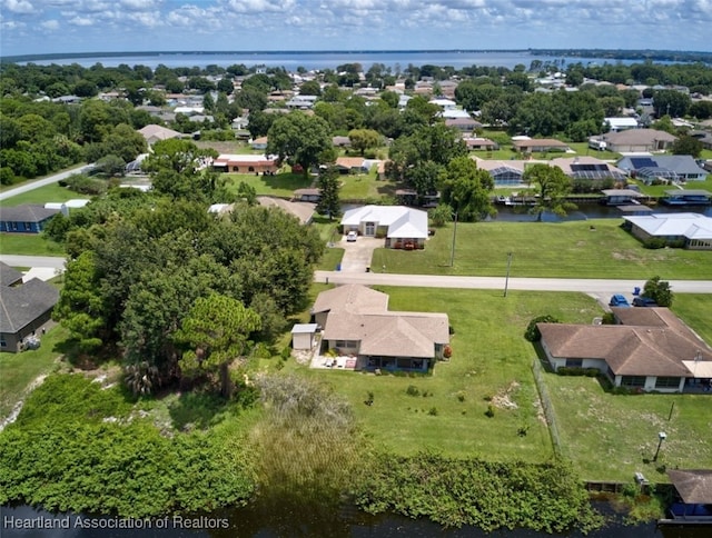 birds eye view of property with a water view