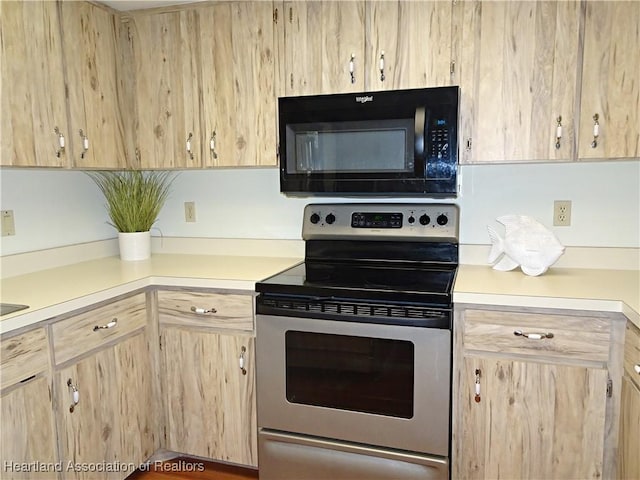 kitchen with light brown cabinets and stainless steel range with electric stovetop