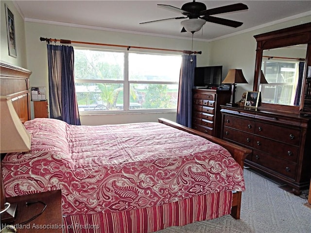 carpeted bedroom with ceiling fan and crown molding