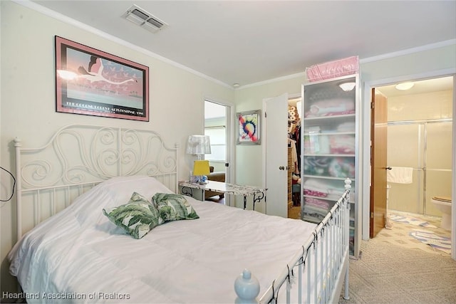 bedroom with connected bathroom, crown molding, a closet, and a walk in closet