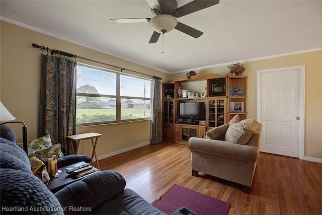 living room with wood-type flooring, ceiling fan, and ornamental molding