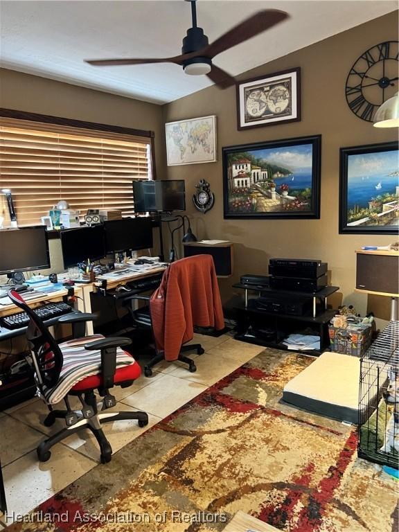 tiled office space with ceiling fan and lofted ceiling