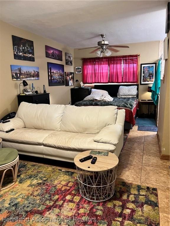 tiled bedroom featuring ceiling fan