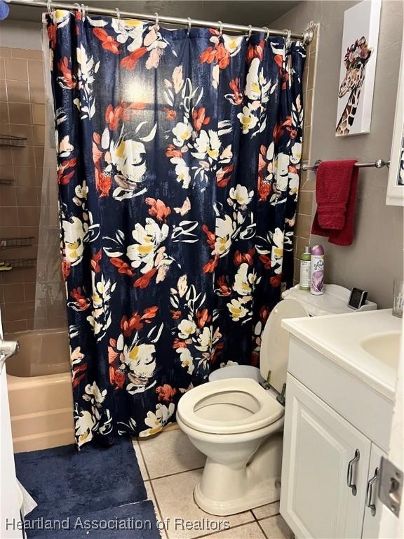 full bathroom with tile patterned flooring, vanity, toilet, and shower / bathtub combination with curtain