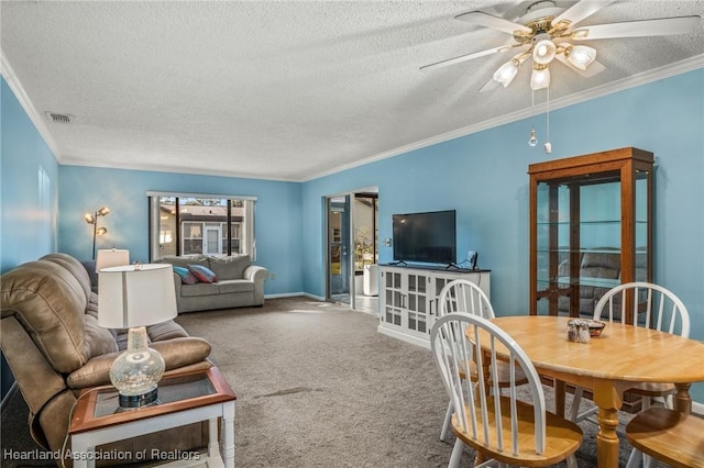 carpeted living room featuring ceiling fan, ornamental molding, and a textured ceiling