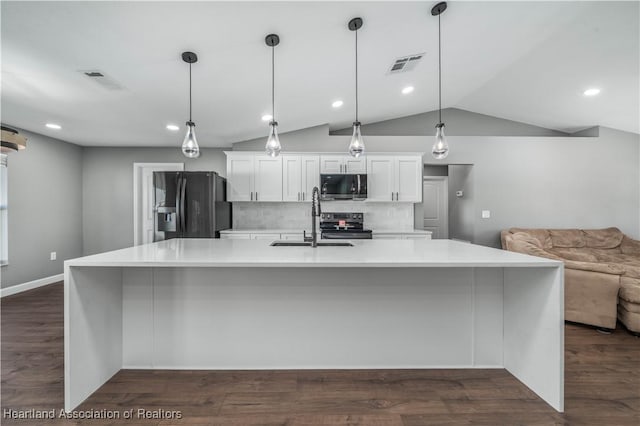 kitchen featuring backsplash, black fridge with ice dispenser, hanging light fixtures, and white cabinets