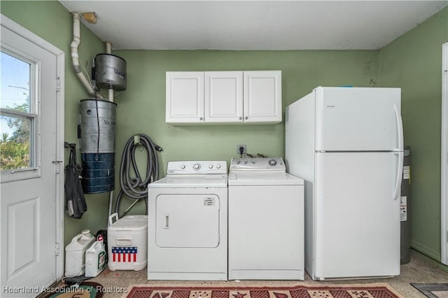 clothes washing area with cabinets and separate washer and dryer