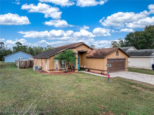 single story home featuring a garage, stucco siding, decorative driveway, and a front lawn