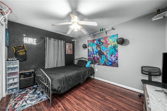 bedroom featuring ceiling fan, baseboards, and wood finished floors