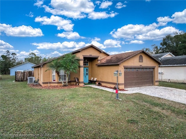 view of front facade featuring stucco siding, decorative driveway, central AC, a front yard, and an attached garage