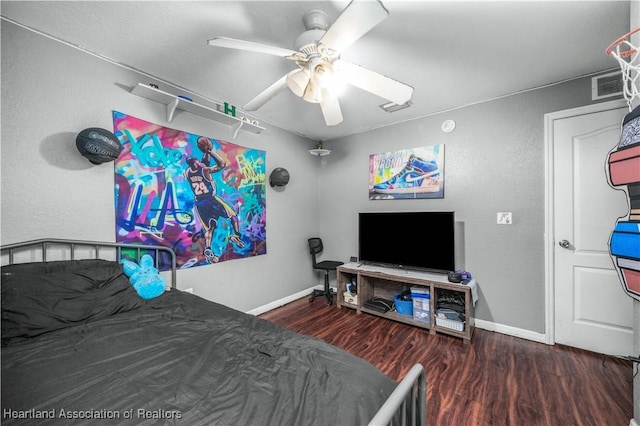 bedroom featuring visible vents, ceiling fan, baseboards, and wood finished floors