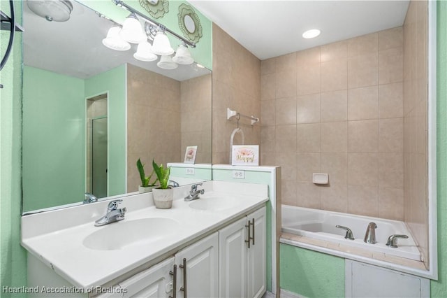 bathroom with double vanity, a garden tub, and a sink