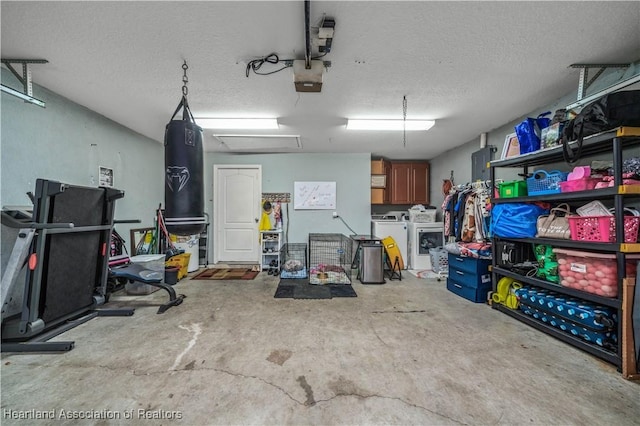 garage featuring a garage door opener and independent washer and dryer