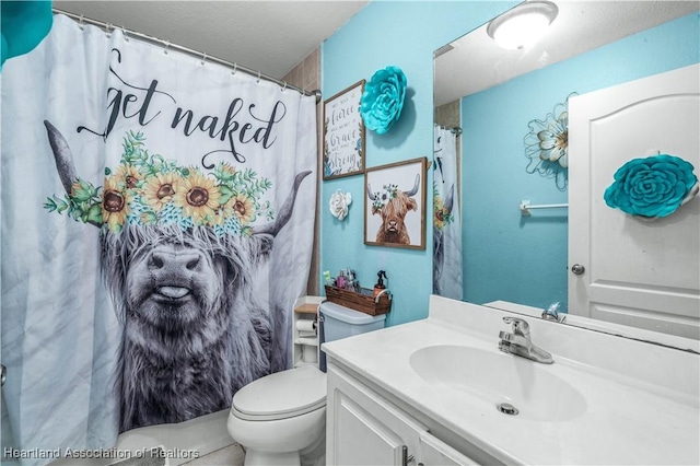 full bathroom with toilet and vanity