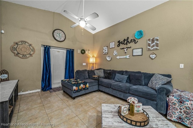 living area with light tile patterned flooring, a ceiling fan, and high vaulted ceiling