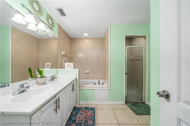 bathroom with a sink, visible vents, a stall shower, and tile patterned flooring