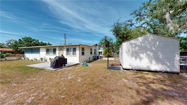 1102 W Gibson St, Arcadia, FL 34266 - rear view of property with a yard, a storage shed, and a patio