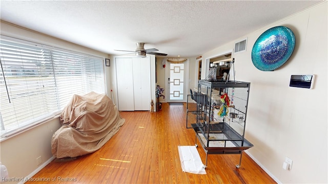 1102 W Gibson St, Arcadia, FL 34266 - living area featuring a ceiling fan, hardwood / wood-style flooring, and a textured ceiling