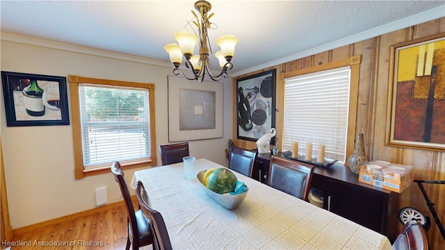 1102 W Gibson St, Arcadia, FL 34266 - dining space featuring a chandelier, wood finished floors, ornamental molding, and wooden walls