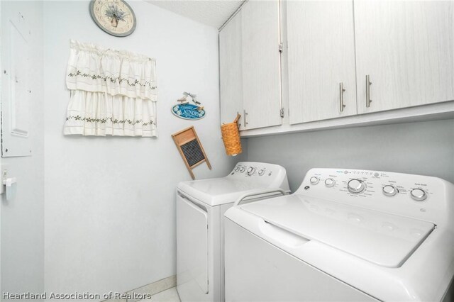 washroom with separate washer and dryer and cabinets