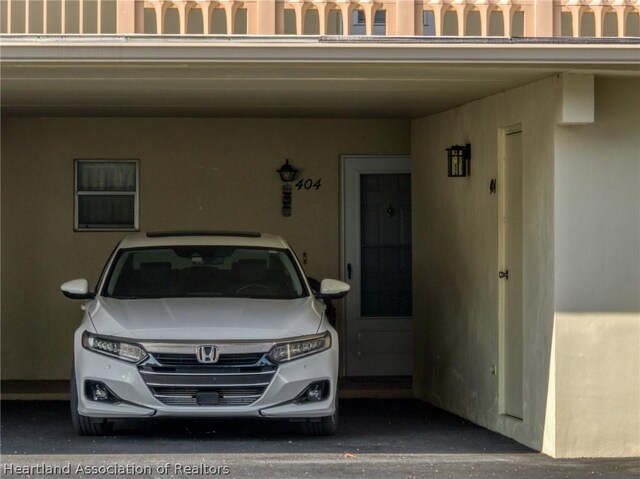 doorway to property featuring a carport