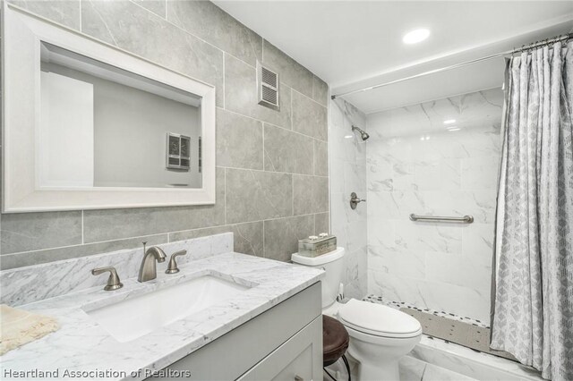 bathroom with vanity, toilet, and walk in shower