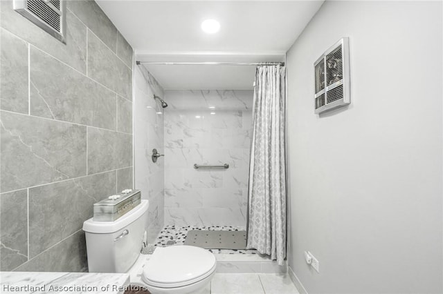 bathroom with toilet, walk in shower, and tile walls