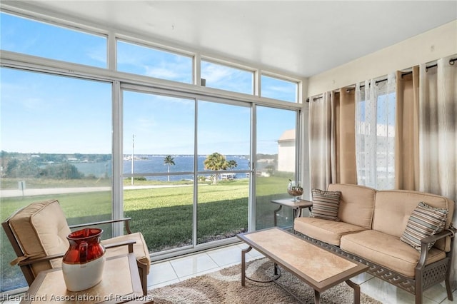 sunroom / solarium featuring a water view