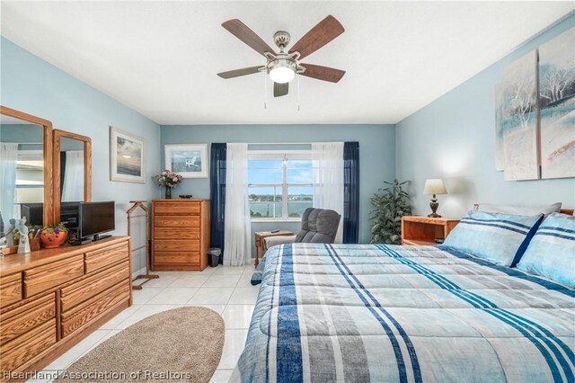 bedroom featuring light tile patterned floors and ceiling fan