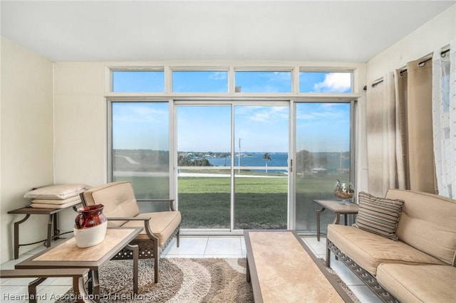 sunroom featuring plenty of natural light and a water view